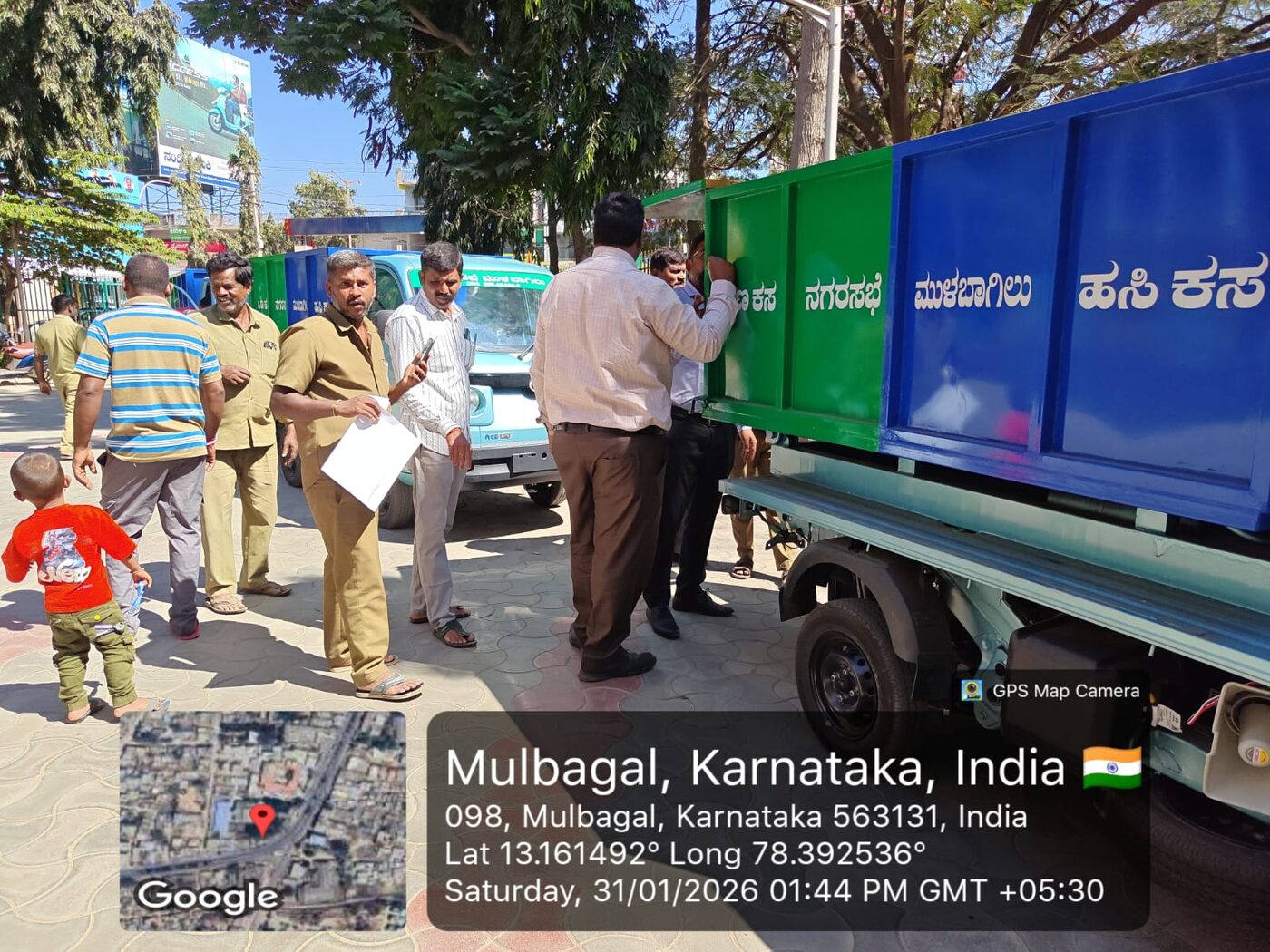 Officials inspecting the segregated waste bin at handover, Mulbagal